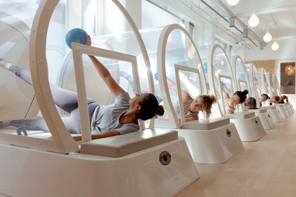 A group of women exercises together in the heated cabin at bbb health boutique.